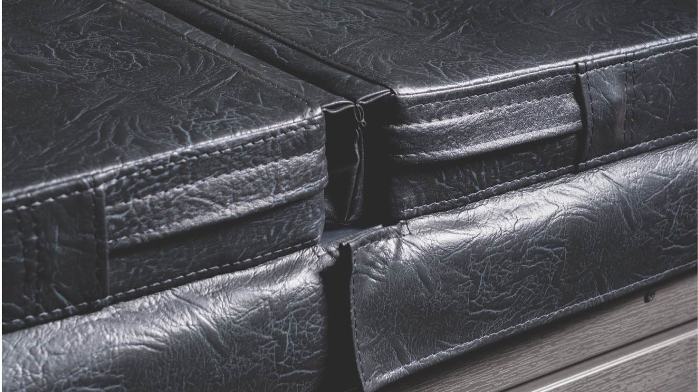 Close-up of a Fisher Spas high-density locking cover, showcasing durable construction and secure locking mechanisms for heat retention and safety.