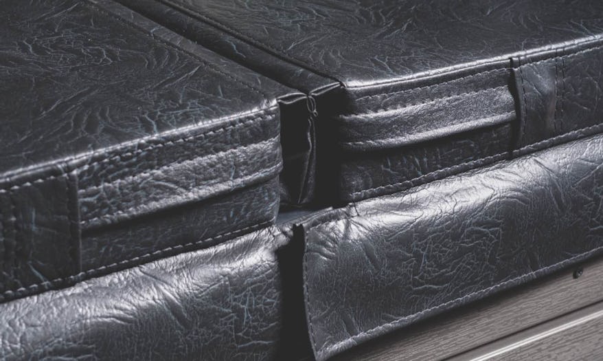 Close-up of a Fisher Spas high-density locking cover, showcasing durable construction and secure locking mechanisms for heat retention and safety.