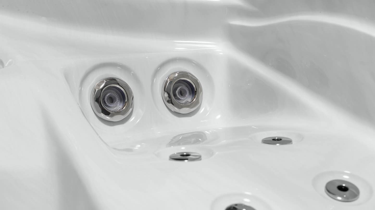 Close-up of Fisher Spas stainless steel massage jets, showcasing their sleek design and precision-engineered functionality for effective hydrotherapy.