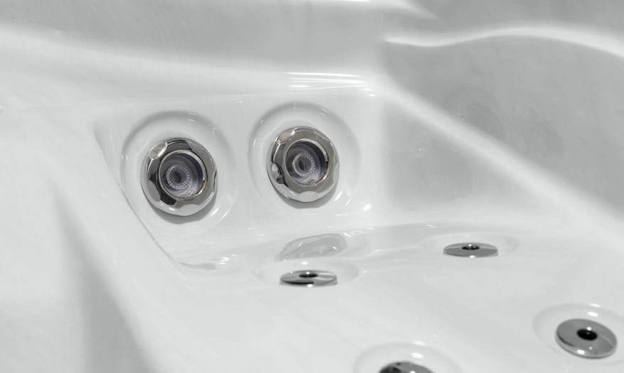 Close-up of Fisher Spas stainless steel massage jets, showcasing their sleek design and precision-engineered functionality for effective hydrotherapy.