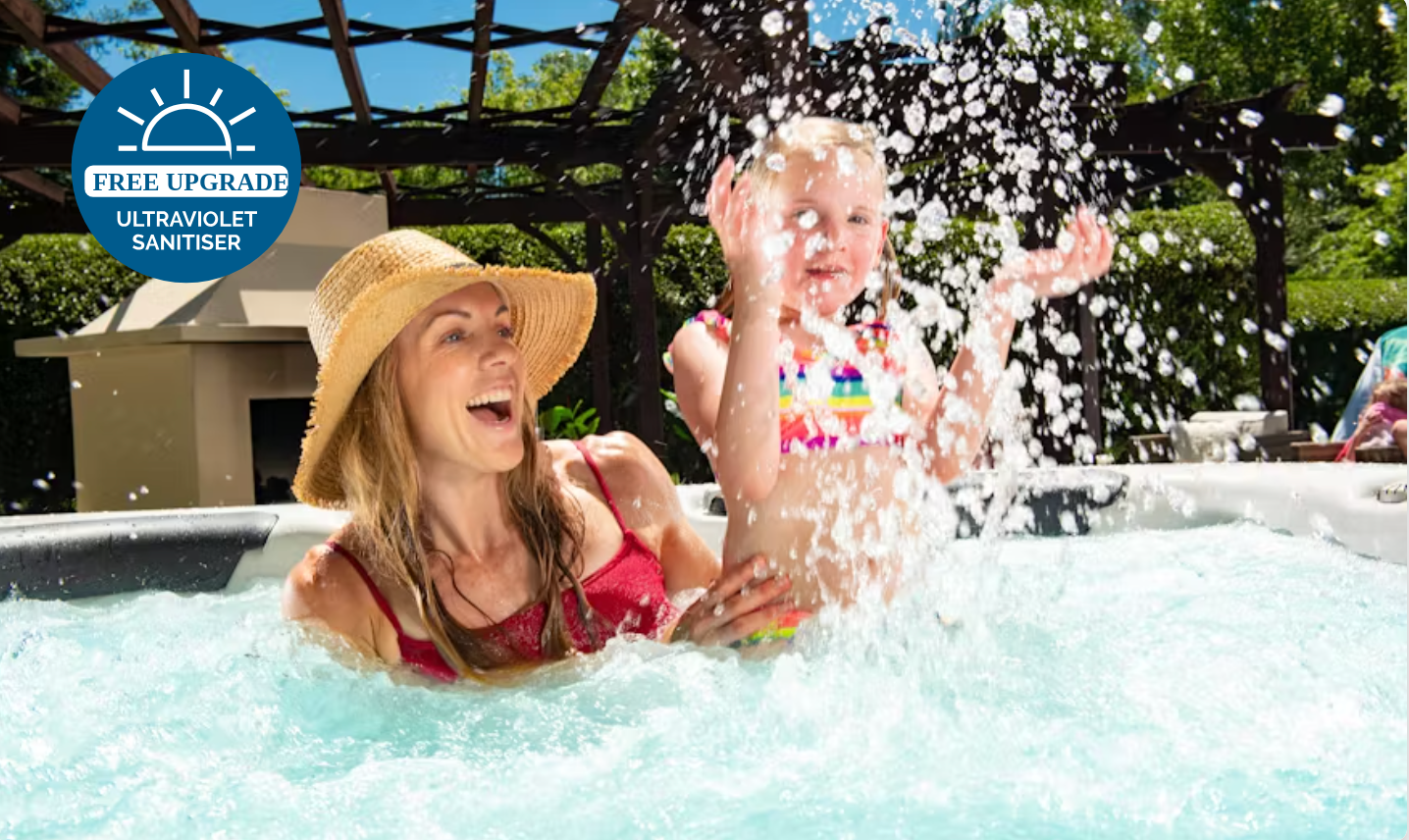 Mother and young child relaxing together in a spa pool, featuring crystal-clear water maintained by a UV sanitiser system.