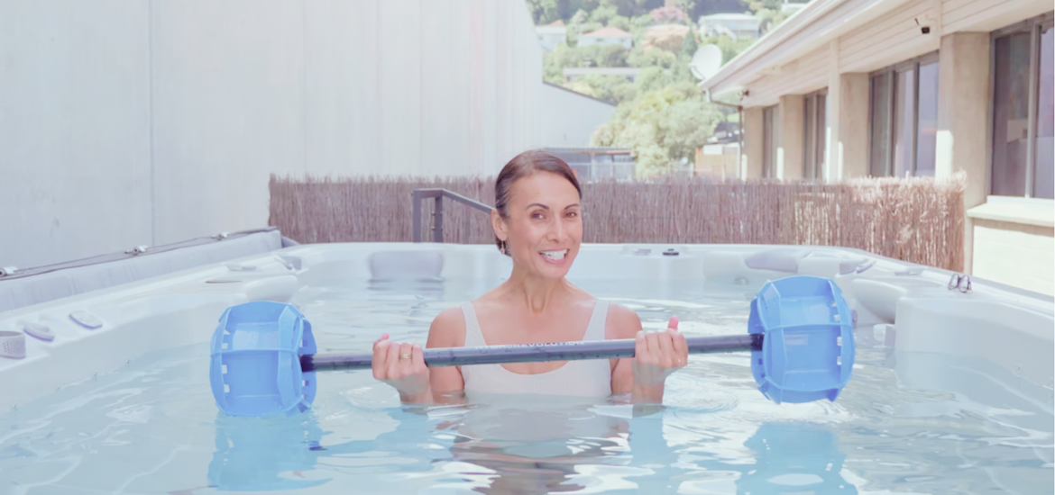 Woman doing upper body workout aqua fitness using Aqua Barbells