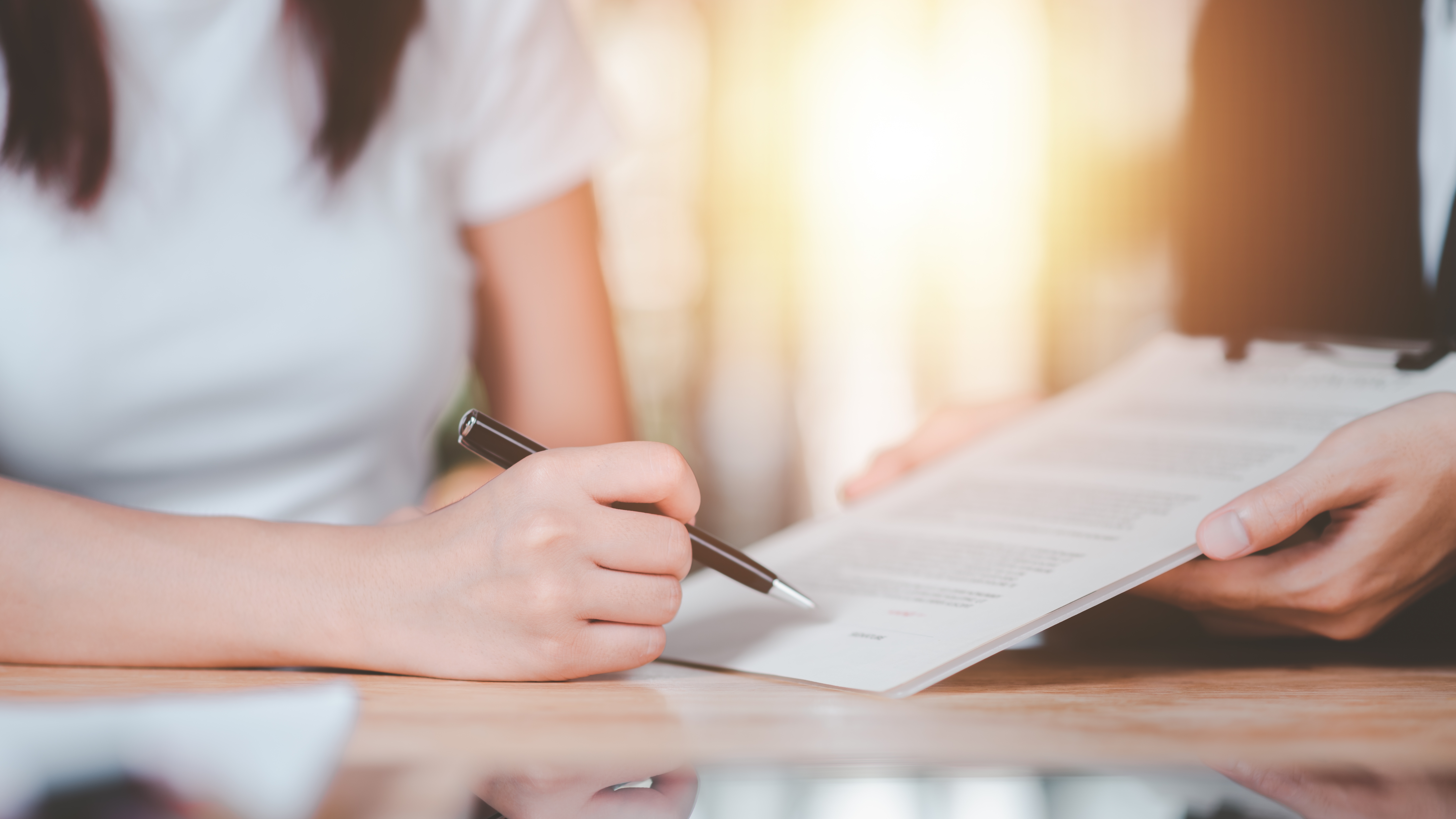 A woman is being shown the warranty contract