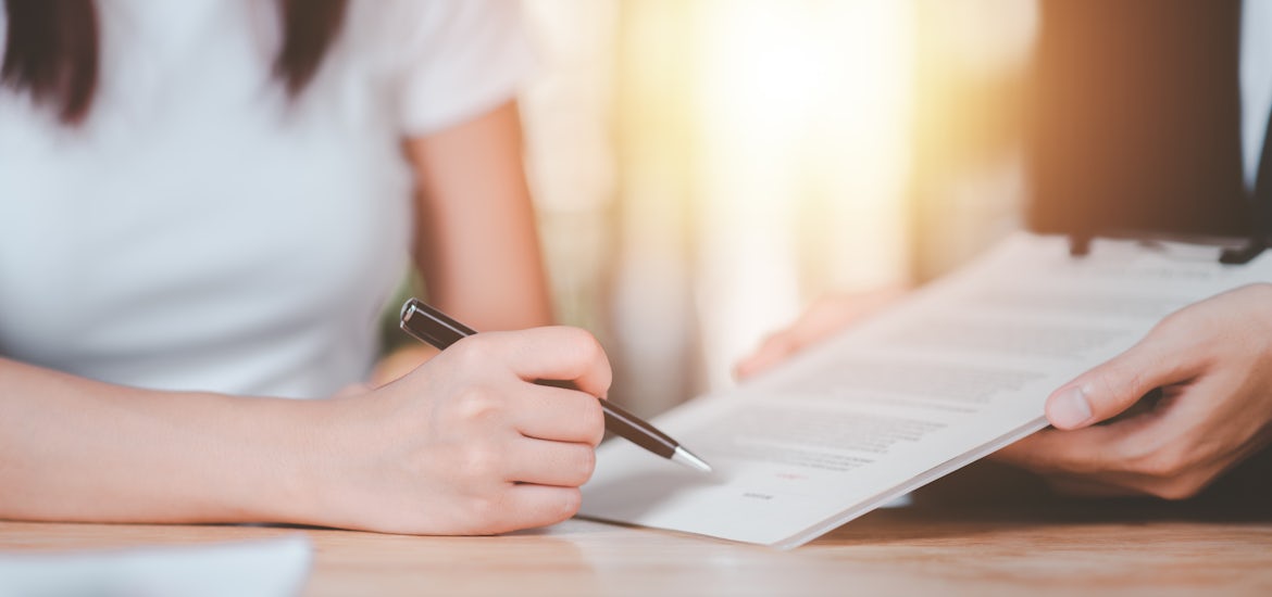 A woman is being shown the warranty contract