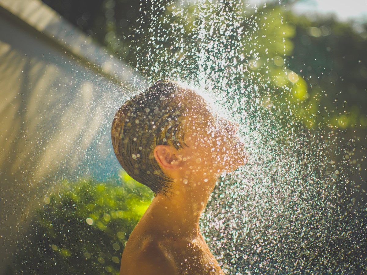 Woman enjoying the outdoor shower