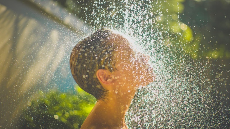 Woman enjoying the outdoor shower