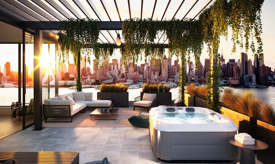 J-315™ hot tub under an outdoor patio overlooking city view