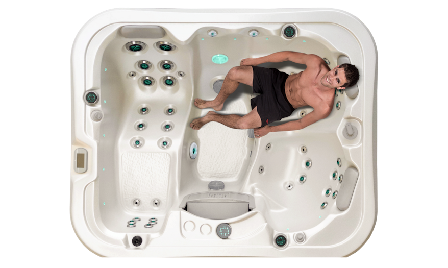 Top down view of the Vortex Neon spa pool with a man on the massage seat