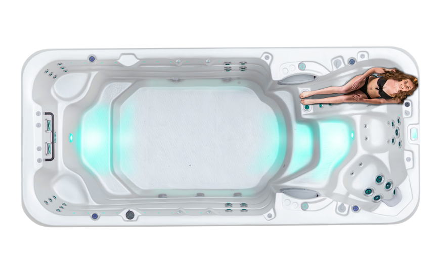 Top down view of the Vortex Aquapace swim spa with a woman on the lounger