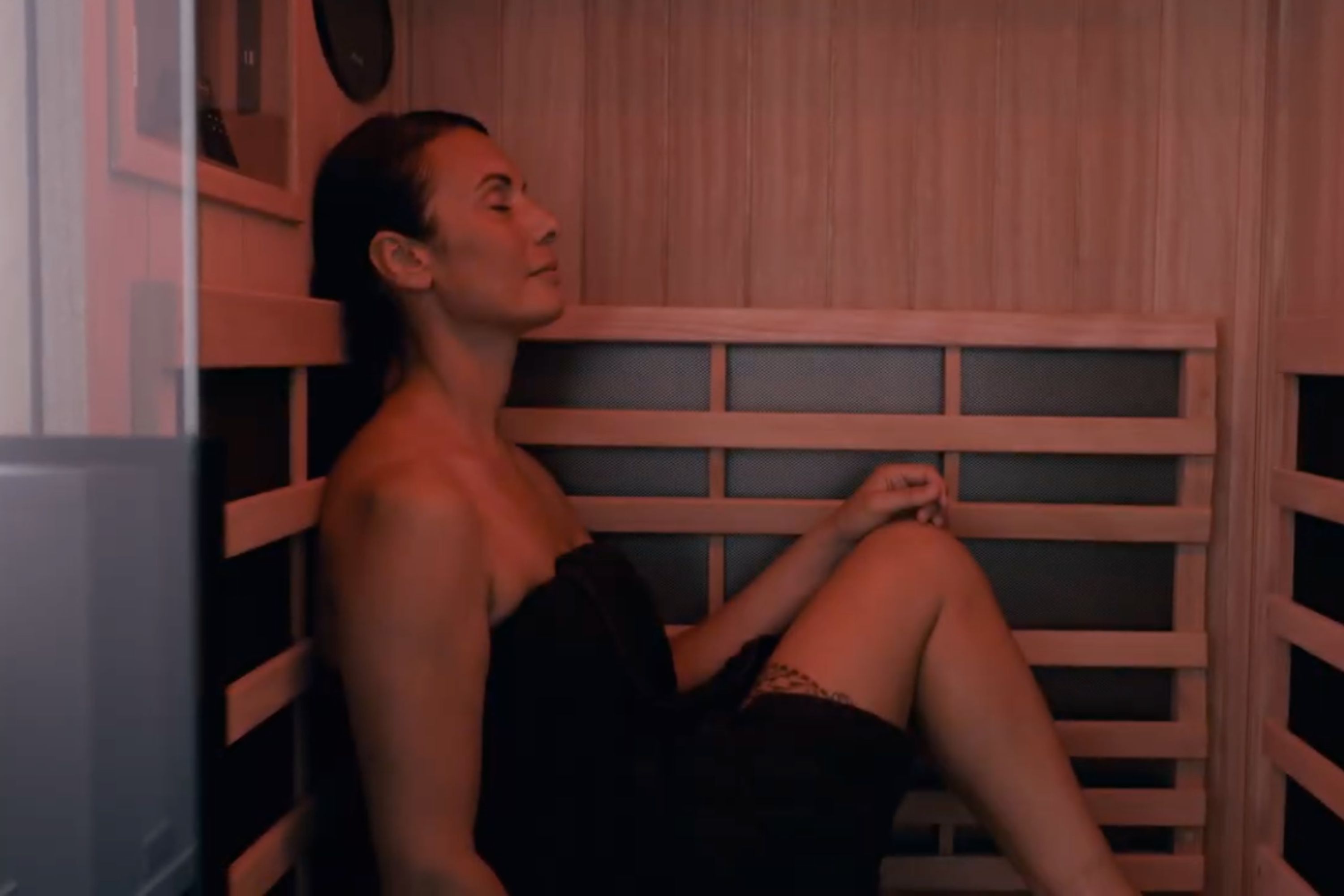 A woman relaxing in an infrared sauna