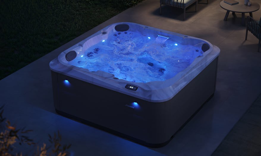 Beautifully-lighted J-201 hot tub at night