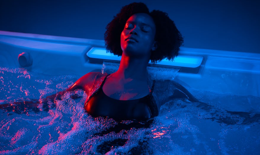 Woman using the waterfall feature of the J509™ hot tub
