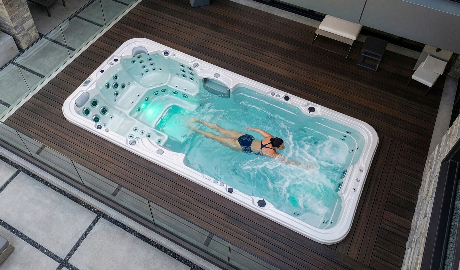 A woman swimming in an Aquagym Max swim spa