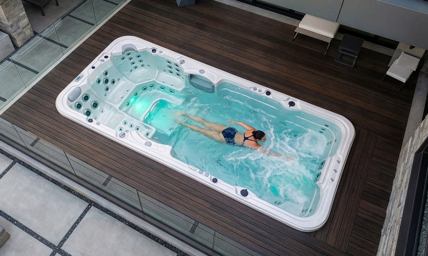 A woman swimming in an Aquagym Max swim spa