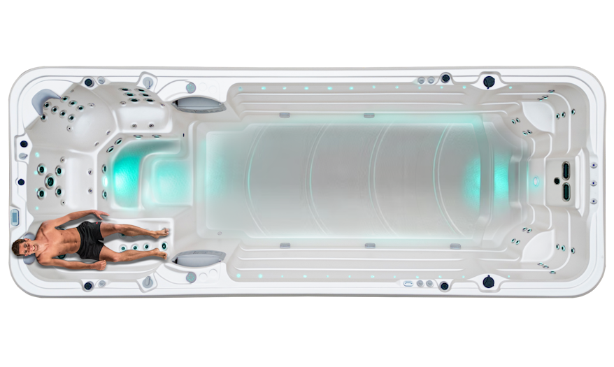 A man on the Vortex Aqualap Extreme's Ergonomic Lounger with Foot Massage