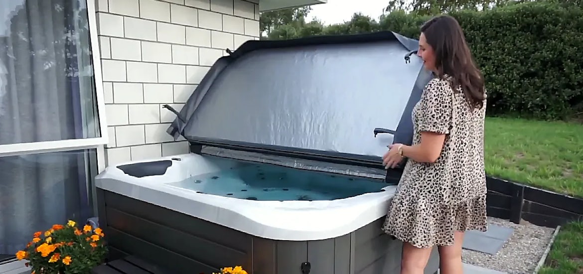 woman lifing a spa cover