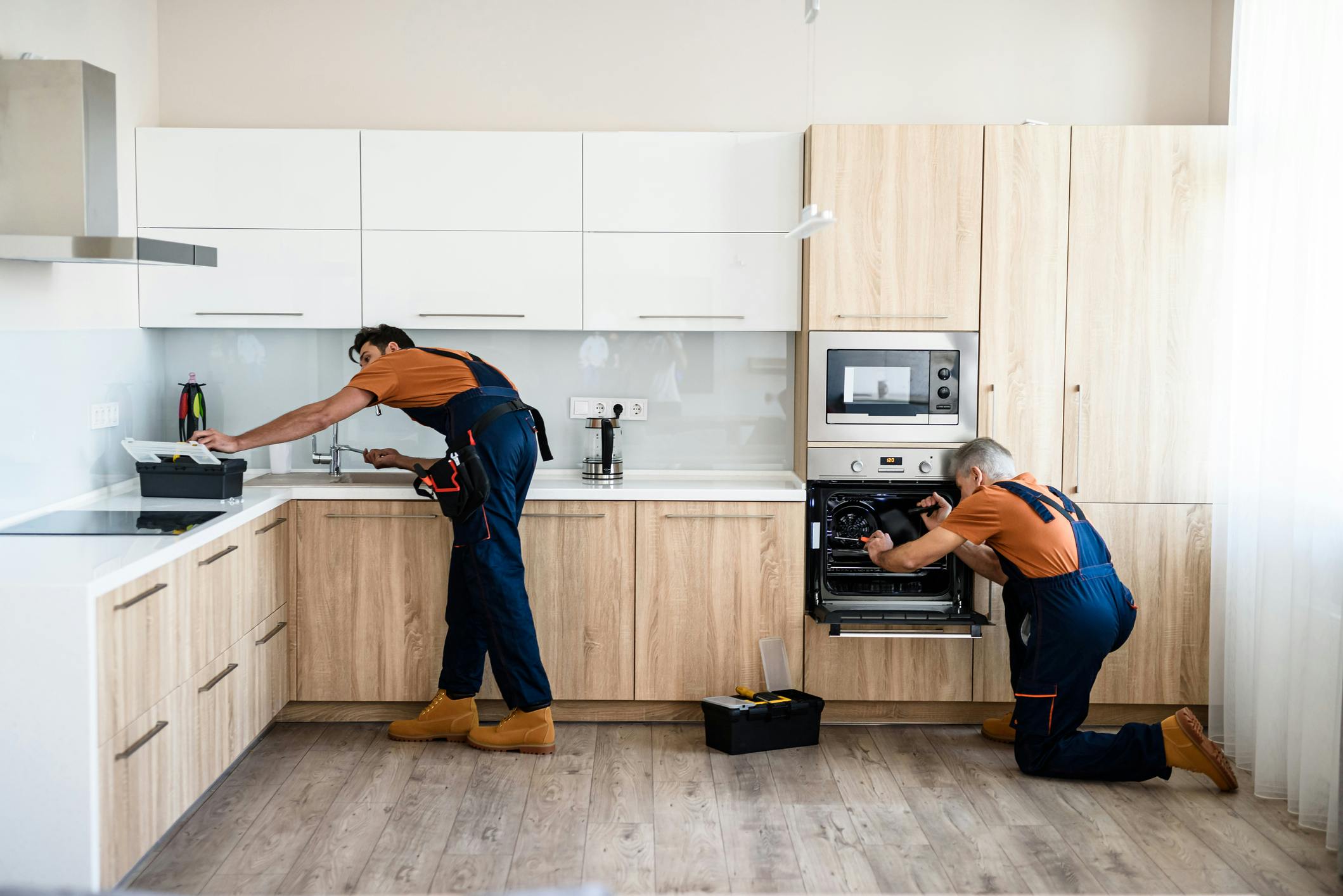 Two men renovating a kitchen
