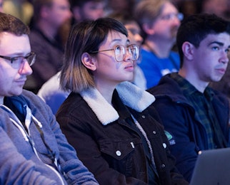 3 people watching presentation at HashiConf 2017.