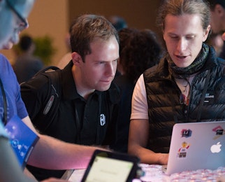 3 people looking at computer at HashiConf 2017.