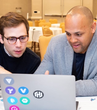 Two HashiCorp staff members working in front of a laptop