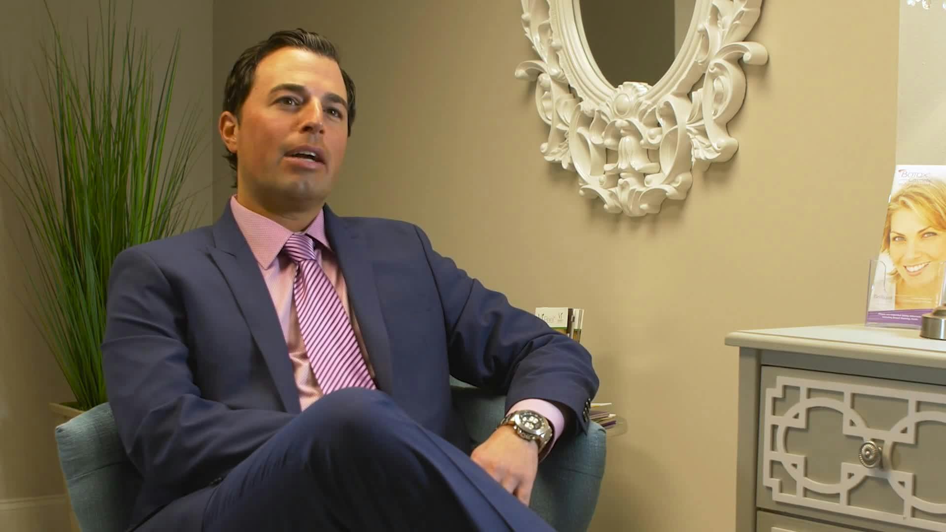 Dr. Corrado Wearing a Suit with a Pink Tie and Shirt