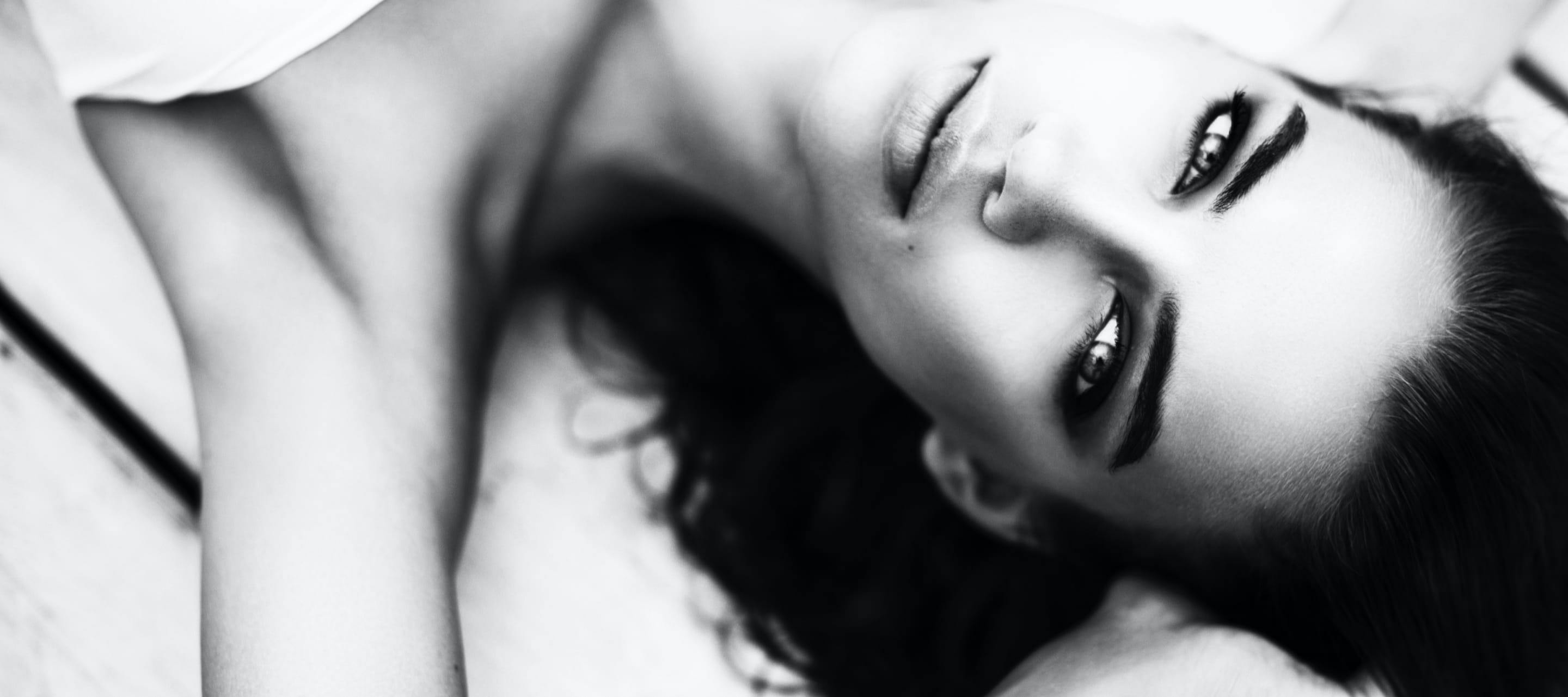 Black and White image of Beautiful model laying down looking up