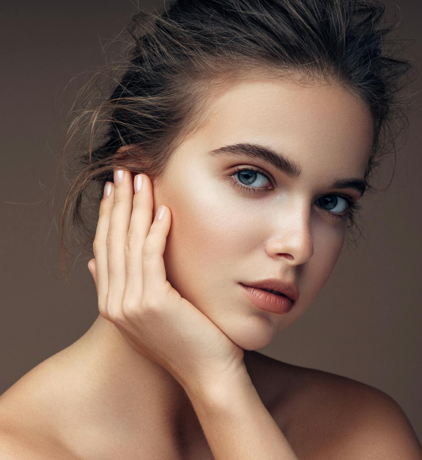 woman touching the side of her face