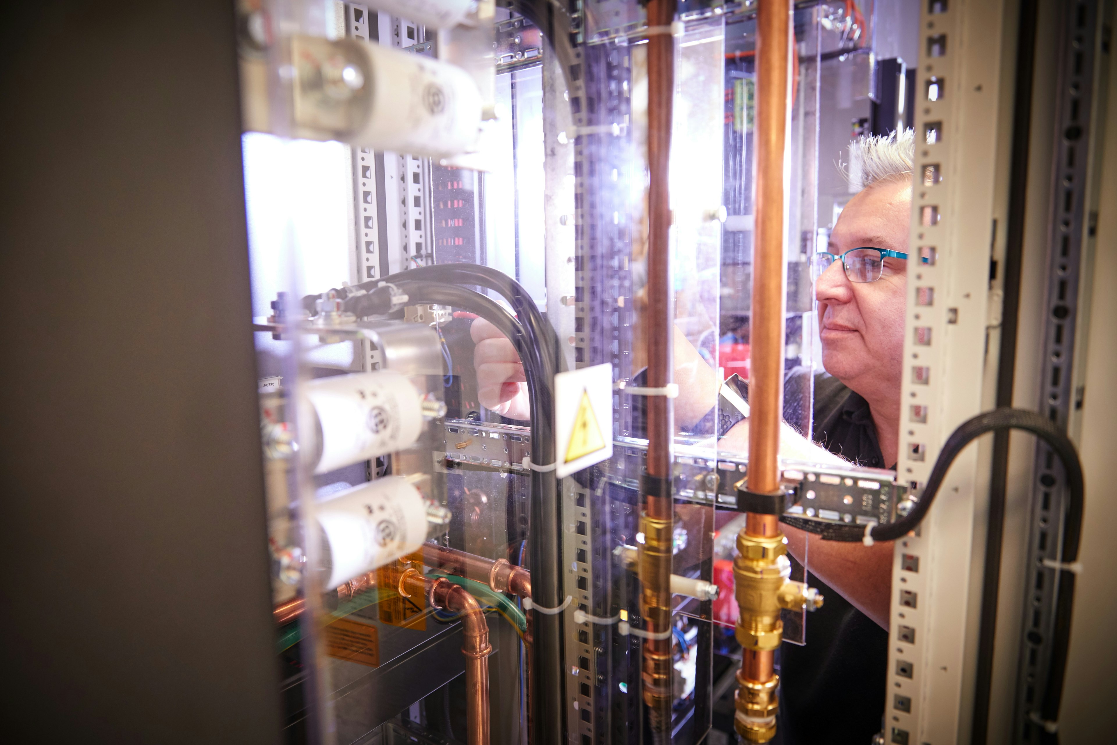 Cambustion technician working on equipment for electric vehicle testing