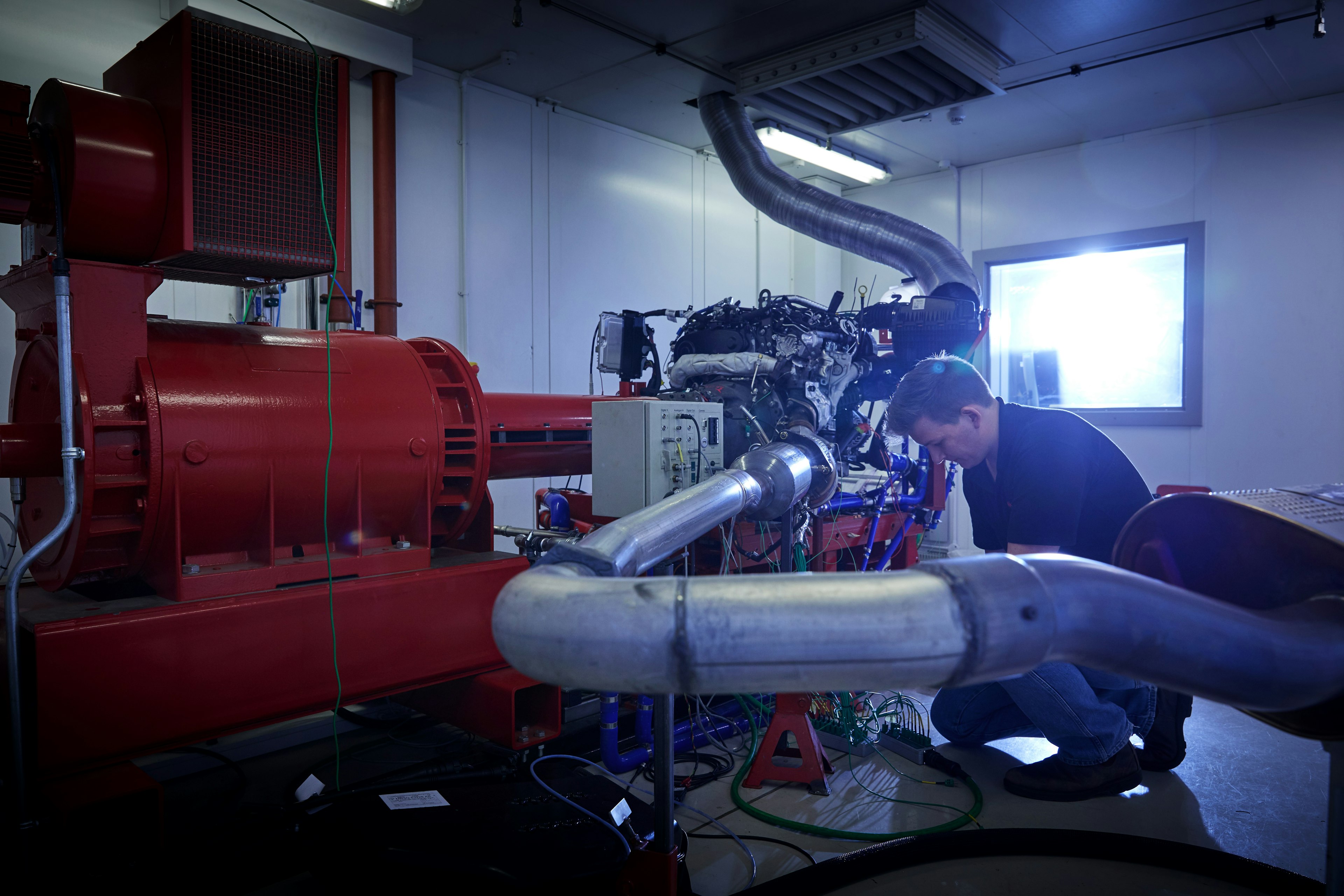 Engineer working on an engine in a Cambustion test cell