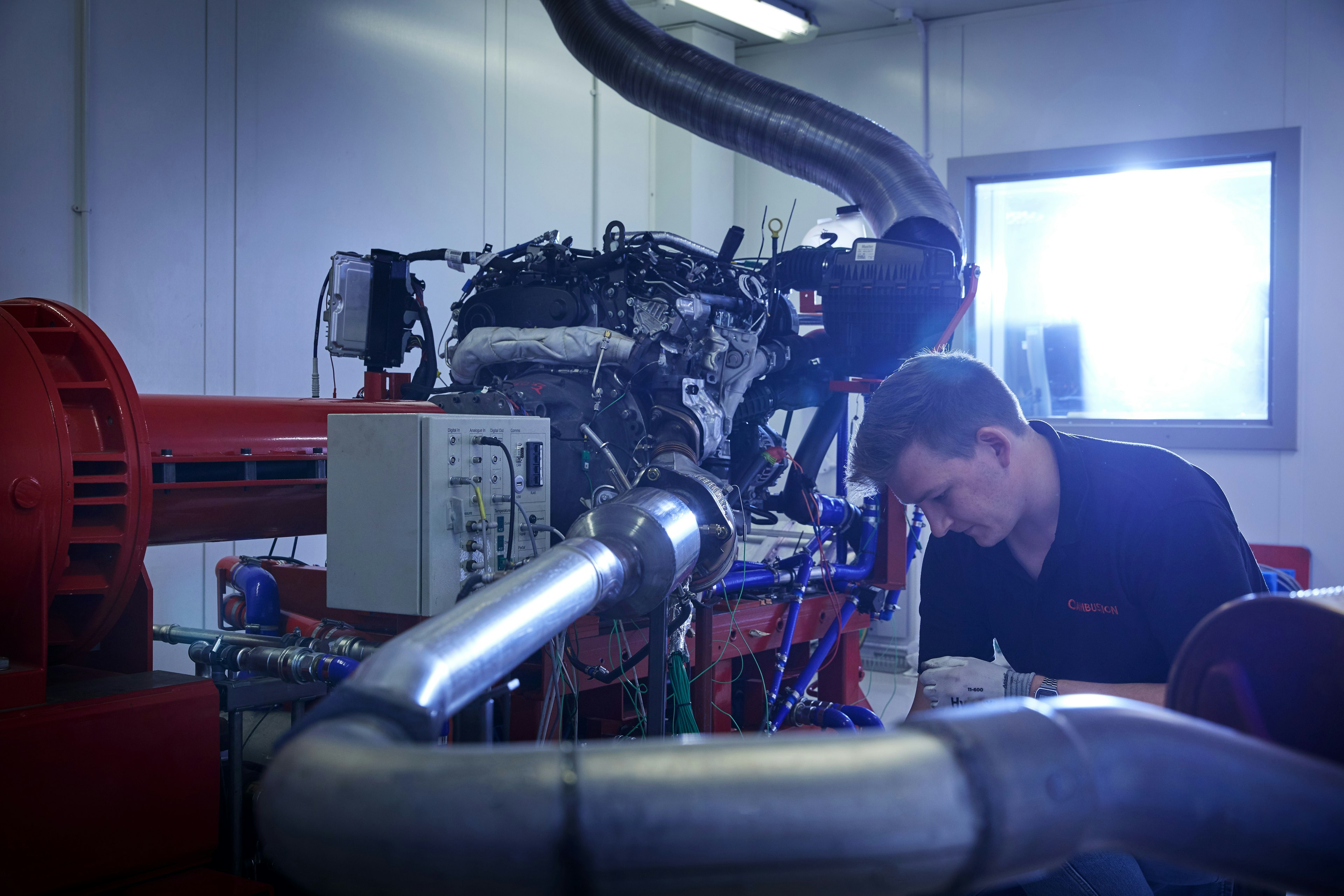Cambustion engineer working on equipment in engine dynamometer