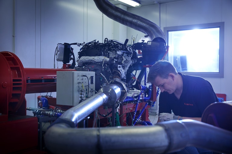 Cambustion engineer working on equipment in engine dynamometer
