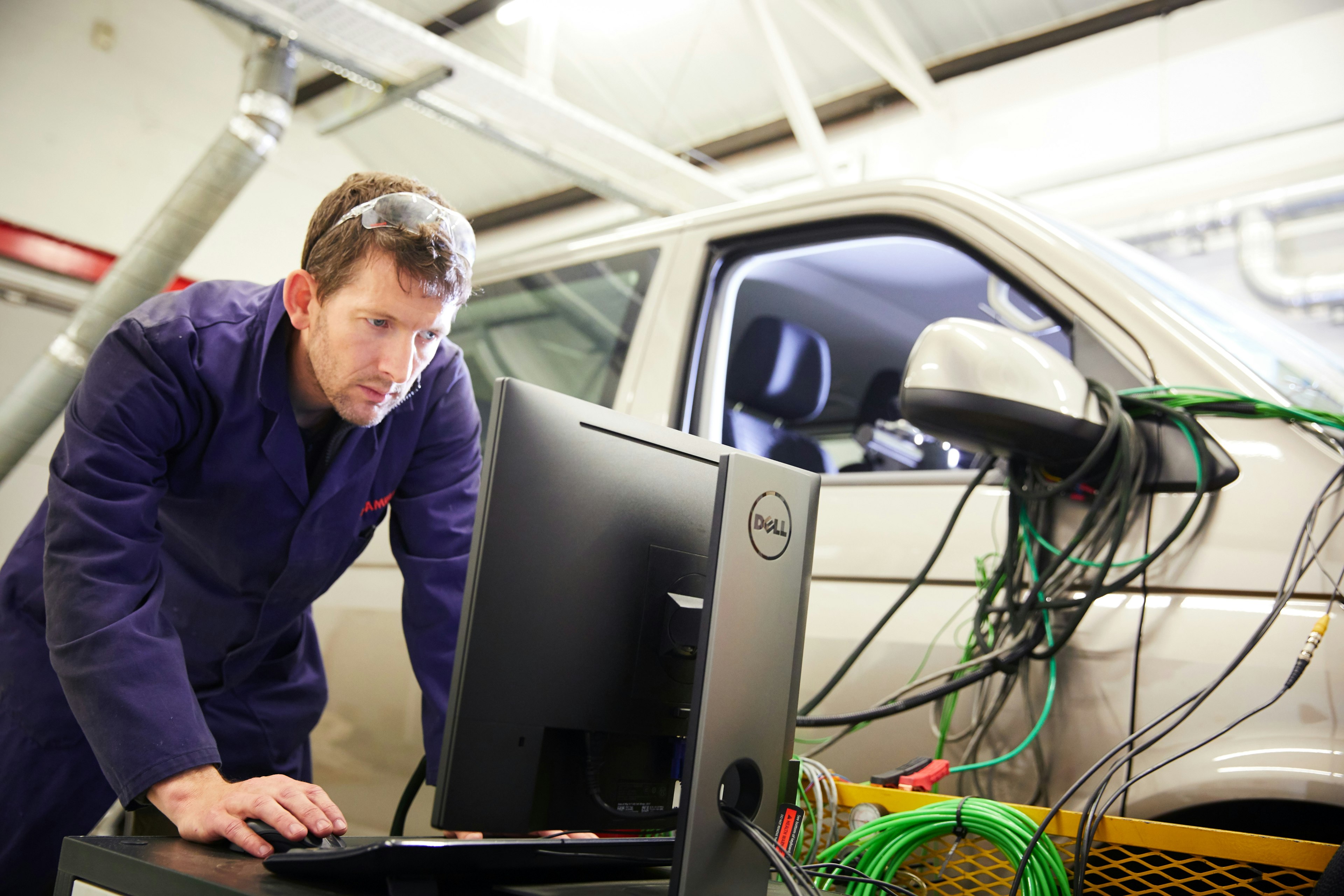 Cambustion engineer looking at screen next to chassis dynamometer