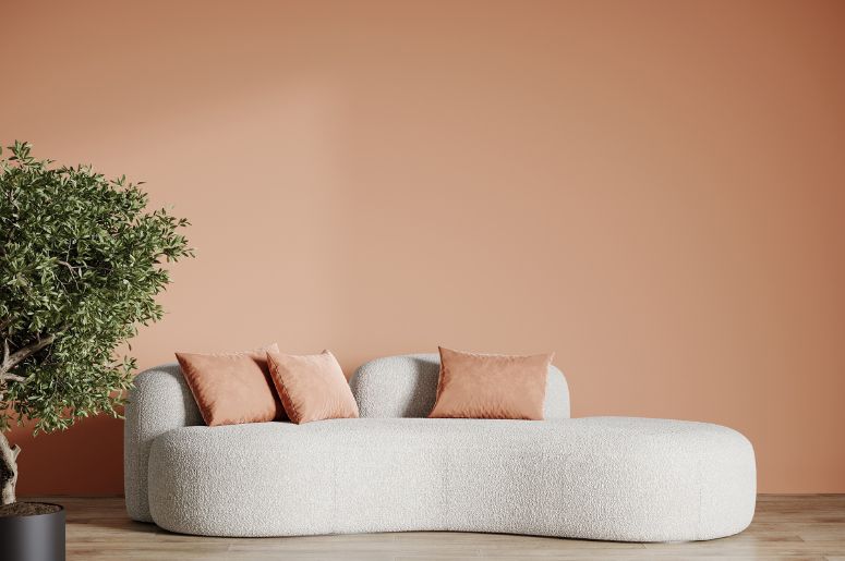 parede e almofadas na cor Peach Fuzz