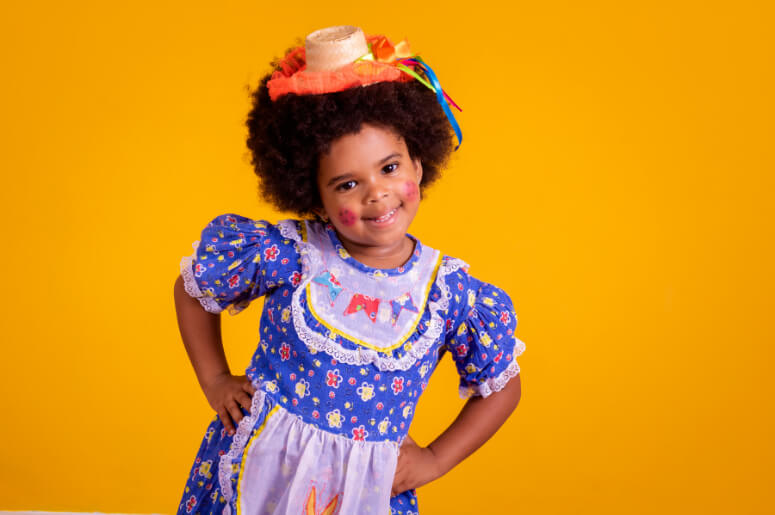 menina com vestido e chapéu de festa junina