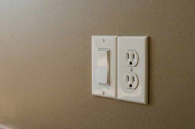 Parede marrom com tomada branca