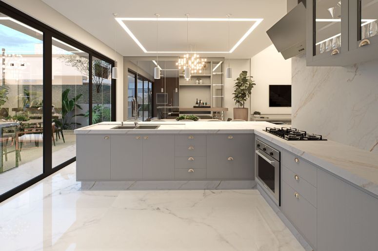 Ambientes integrados com cozinha moderna, ilha central, sala de jantar ao fundo, grandes portas de vidro e área externa conectada ao espaço interno