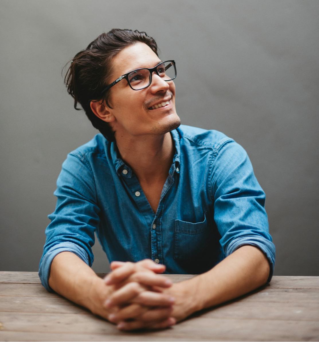 Man sitting at desk smiling.