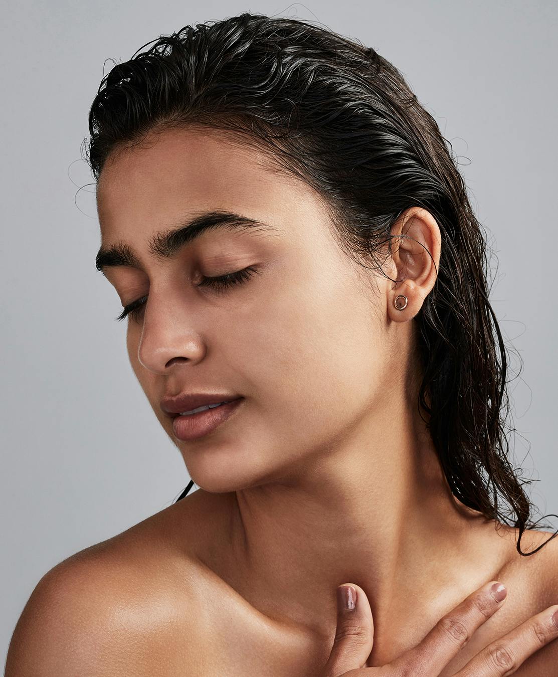 Woman with wet hair looking to the side.