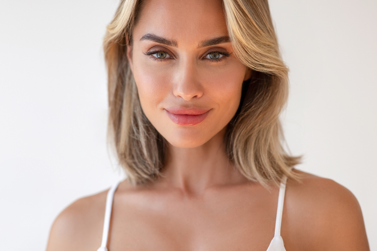 A blonde woman smiling at camera