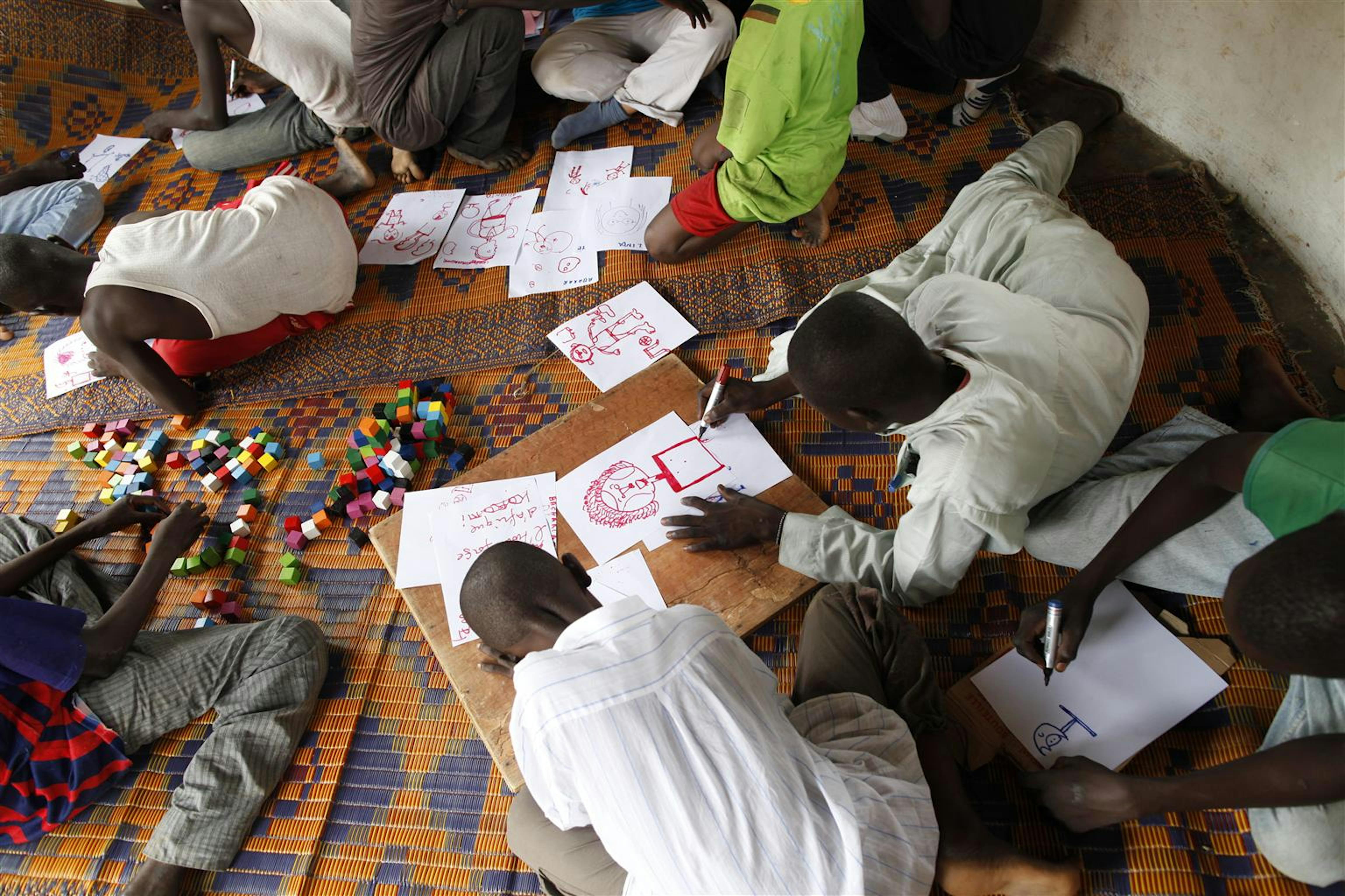 Minori smobilitati dalle milizie armate disegnano e giocano in un Centro di transito finanziato dall'UNICEF a N'dele, nel nord della Repubblica Centrafricana - ©UNICEF/NYHQ2012-1160/Brian Sokol