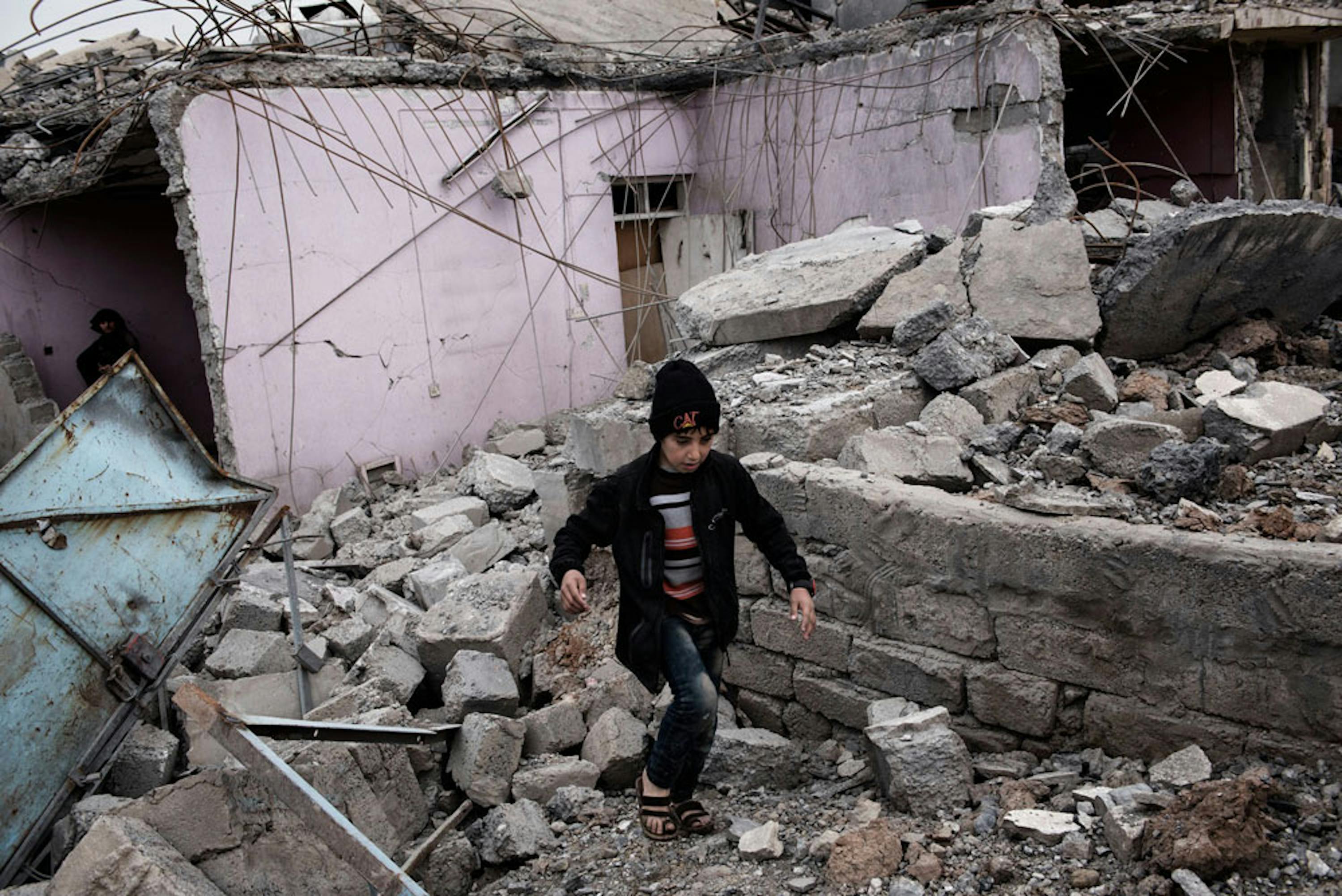 Un bambino fra le macerie di un edificio distrutto da un bombardamento aereo a Mosul Ovest, teatro di violentissimi combattimenti tra forze di sicurezza irachene e ISIS  - ©UNICEF/UN057866/Romenzi