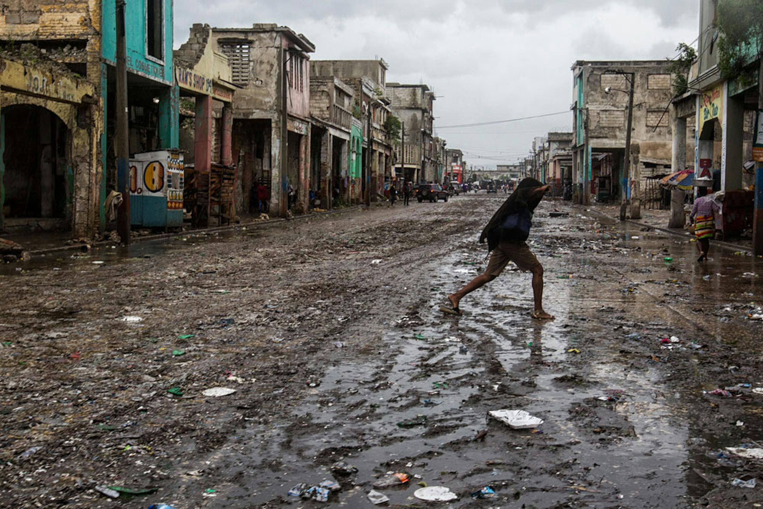 Una donna attraversa una strada allagata a Port-au-Prince, capitale di Haiti - ©UNICEF/UN034468/Abassi/UN MINUSTAH