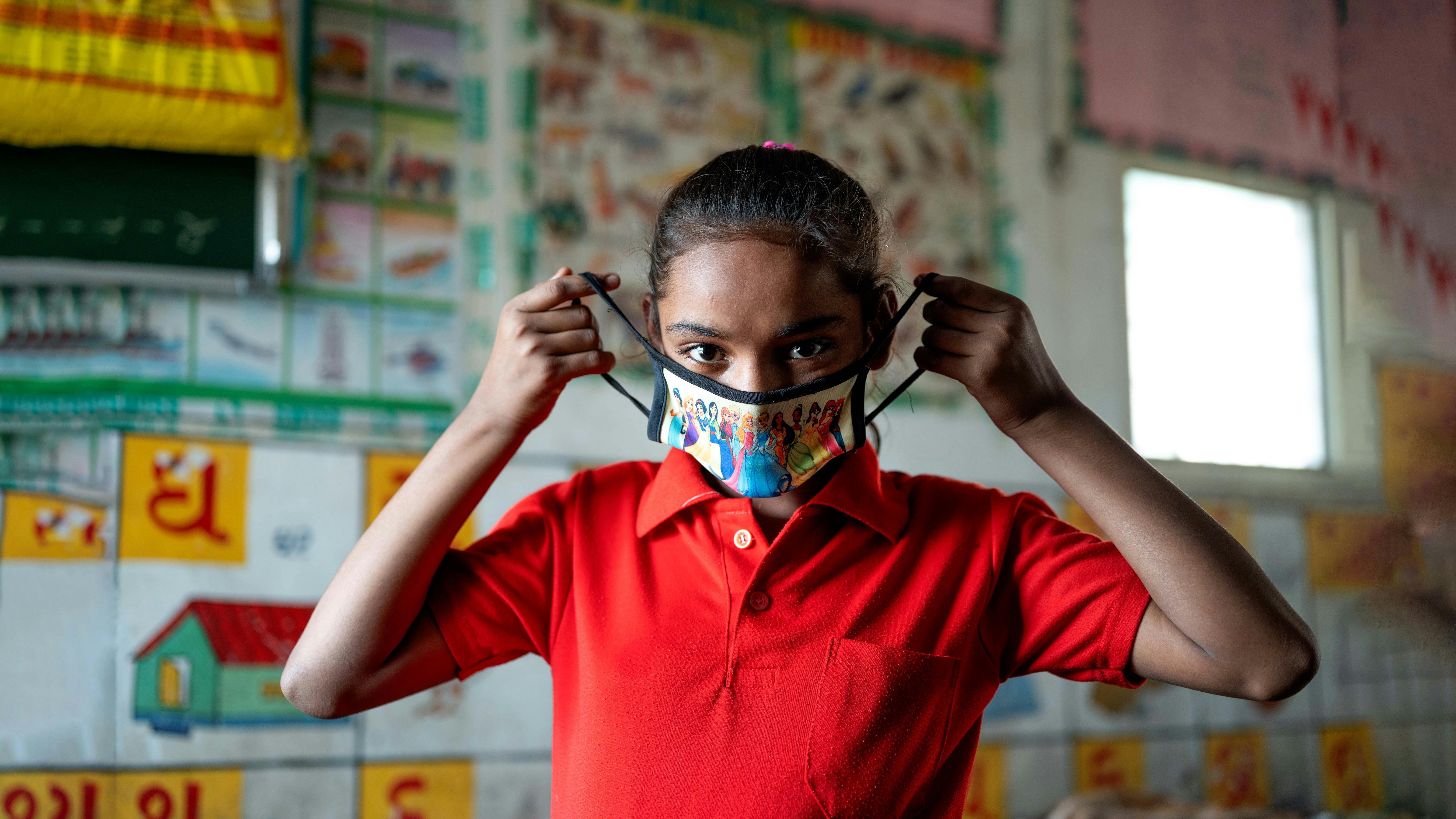 India, una bambina indossa la mascherina prima di partecipare a una sessione con i volontari