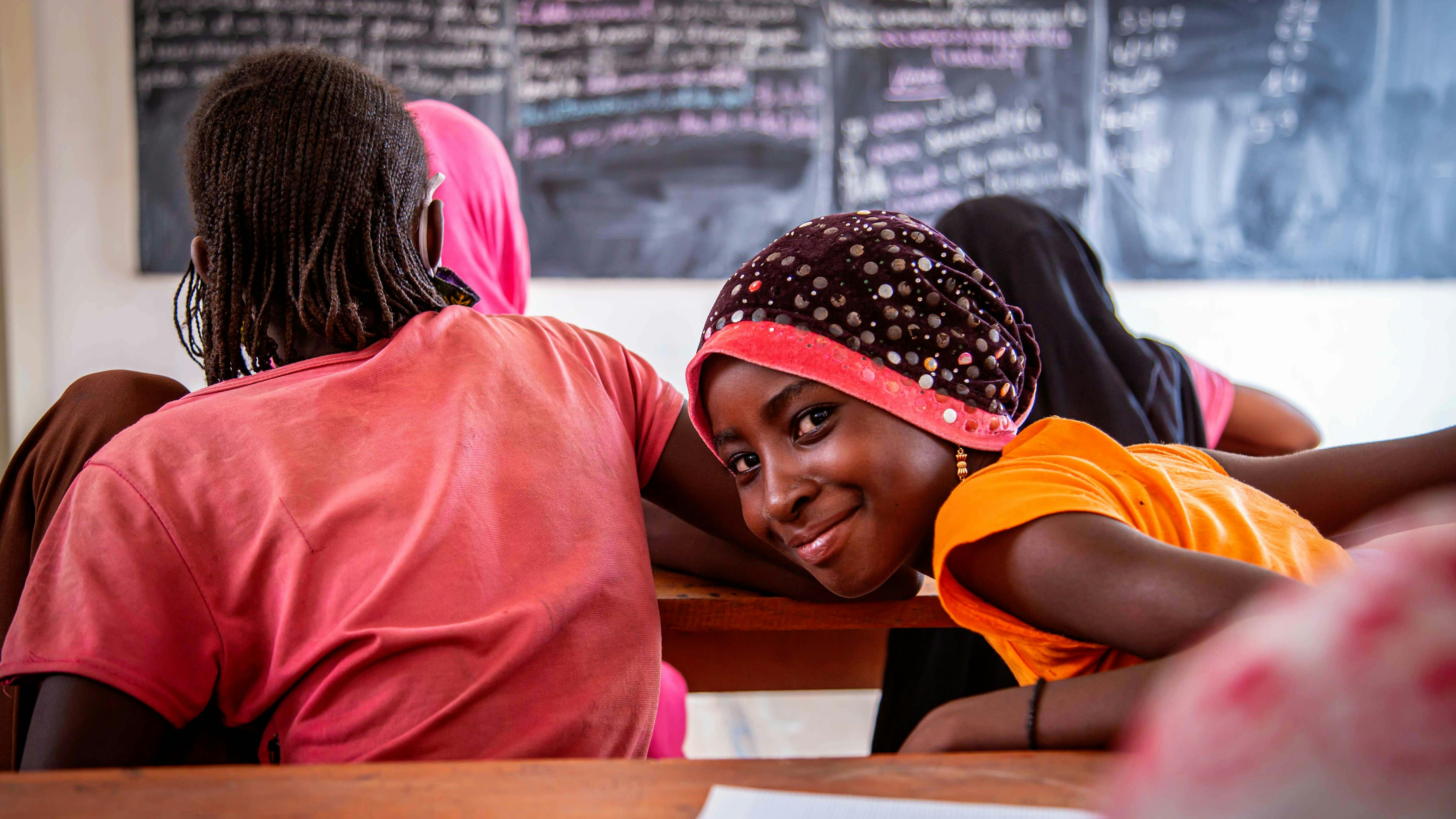 Mauritania, una studentessa sorride mentre partecipa a una lezione presso la Scuola 8 riabilitata dell'UNICEF nel campo di Mbera.