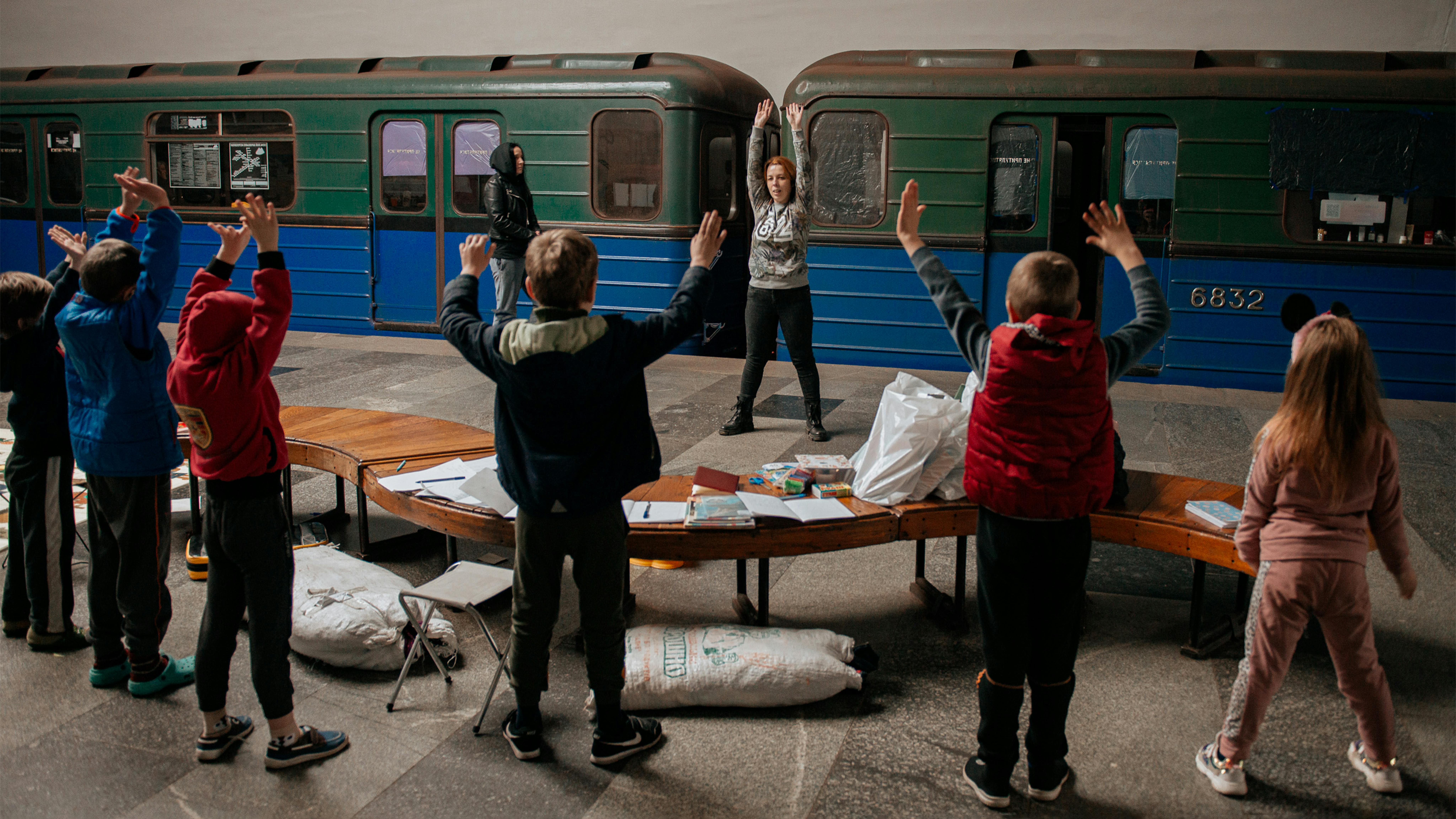 La volontaria Yuliia Kruhlaia, 41 anni, conduce una lezione di riscaldamento per bambini in una delle stazioni della metropolitana di Kharkiv.