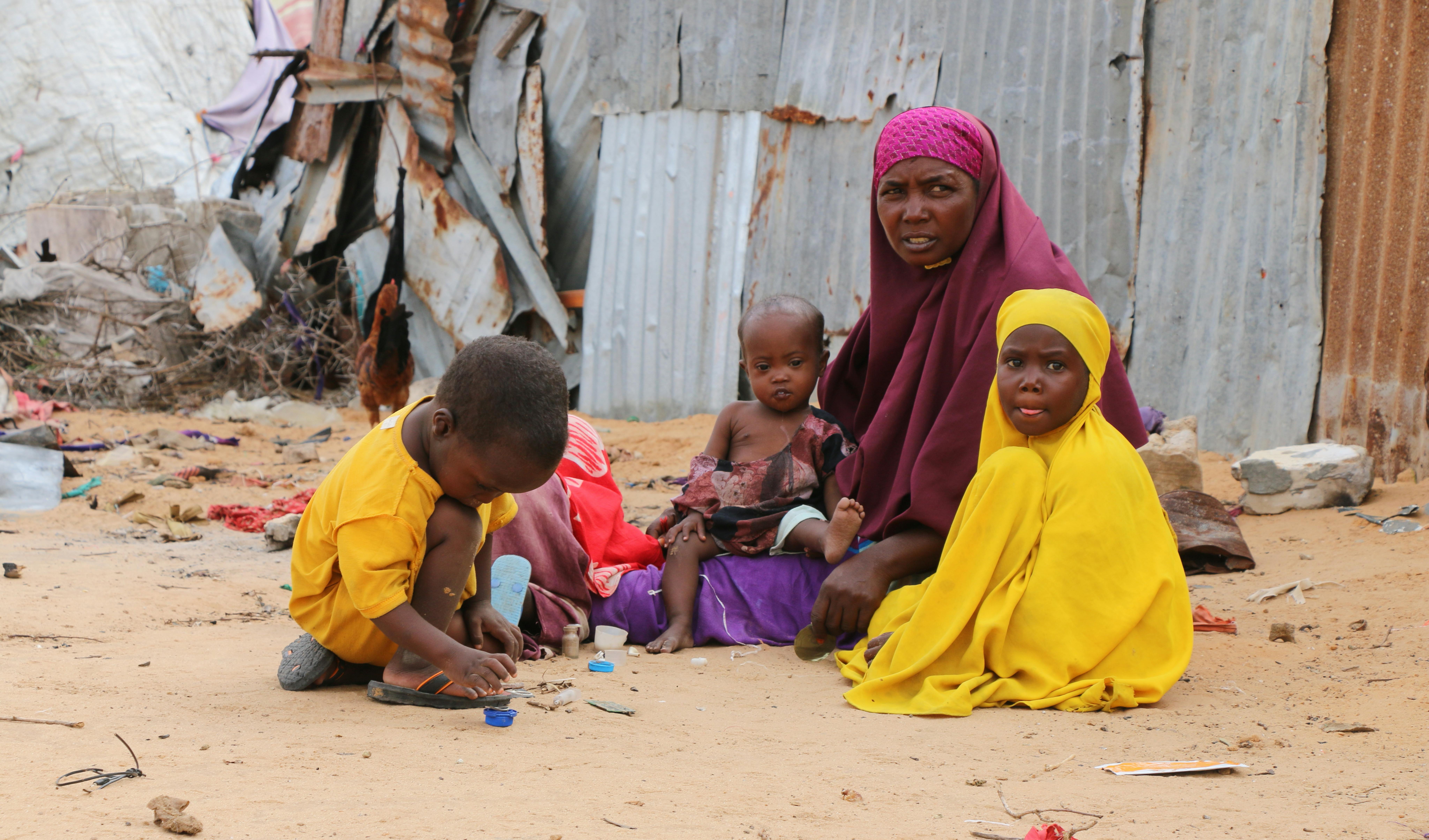 Khadijo  ei suoi figli sono seduti fuori dal campo di Gurman per sfollati interni, alla periferia di Mogadiscio, in Somalia.