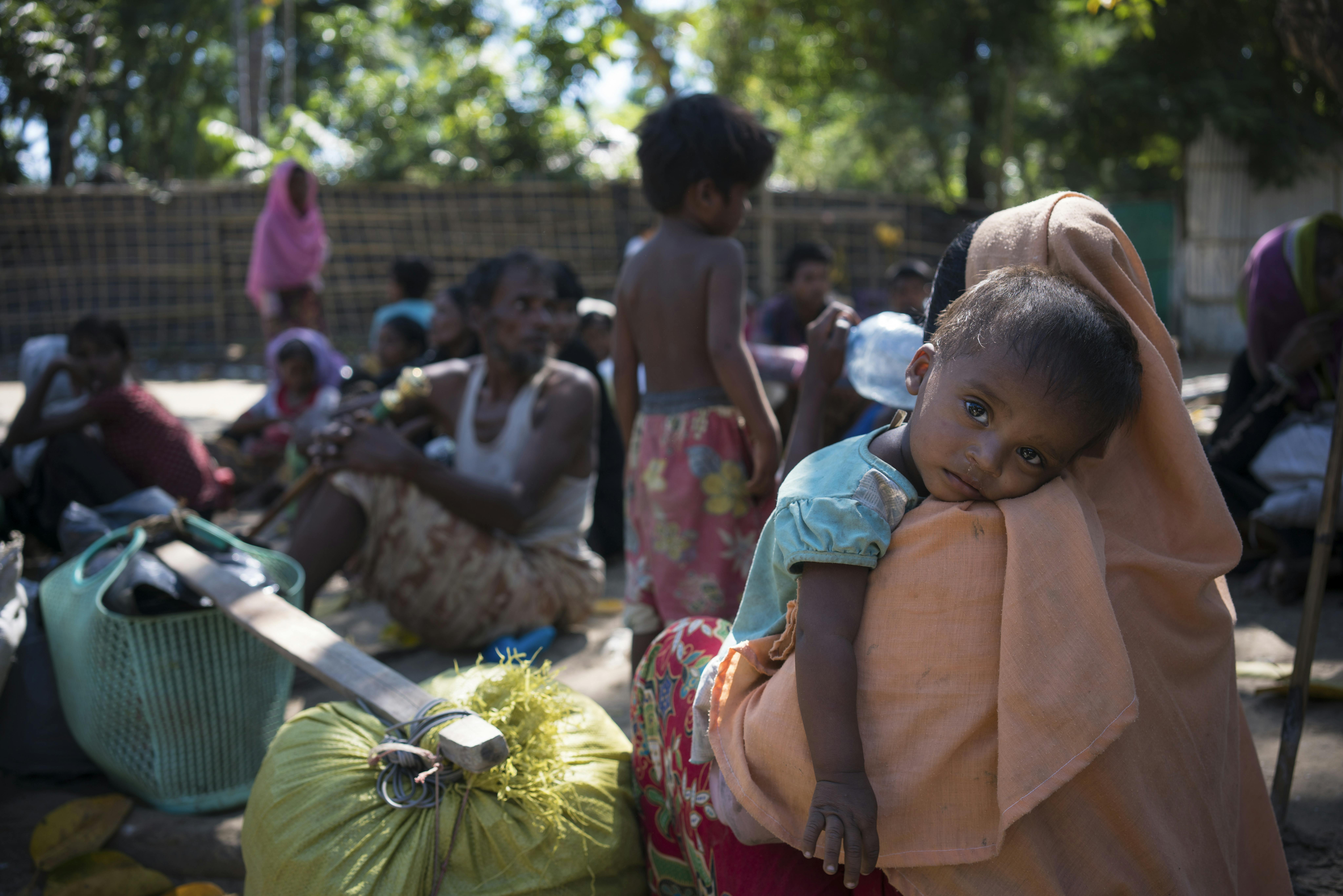 Una mamma Rohyngia tiene in braccio il suo bambino mentre si trovano in un rifugio per sfollati, in Bangladesh. Le famiglie Rohingya fuggite dalle violenze vivono ancora nell'incertezza nel più grande insediamento di rifugiati del mondo.