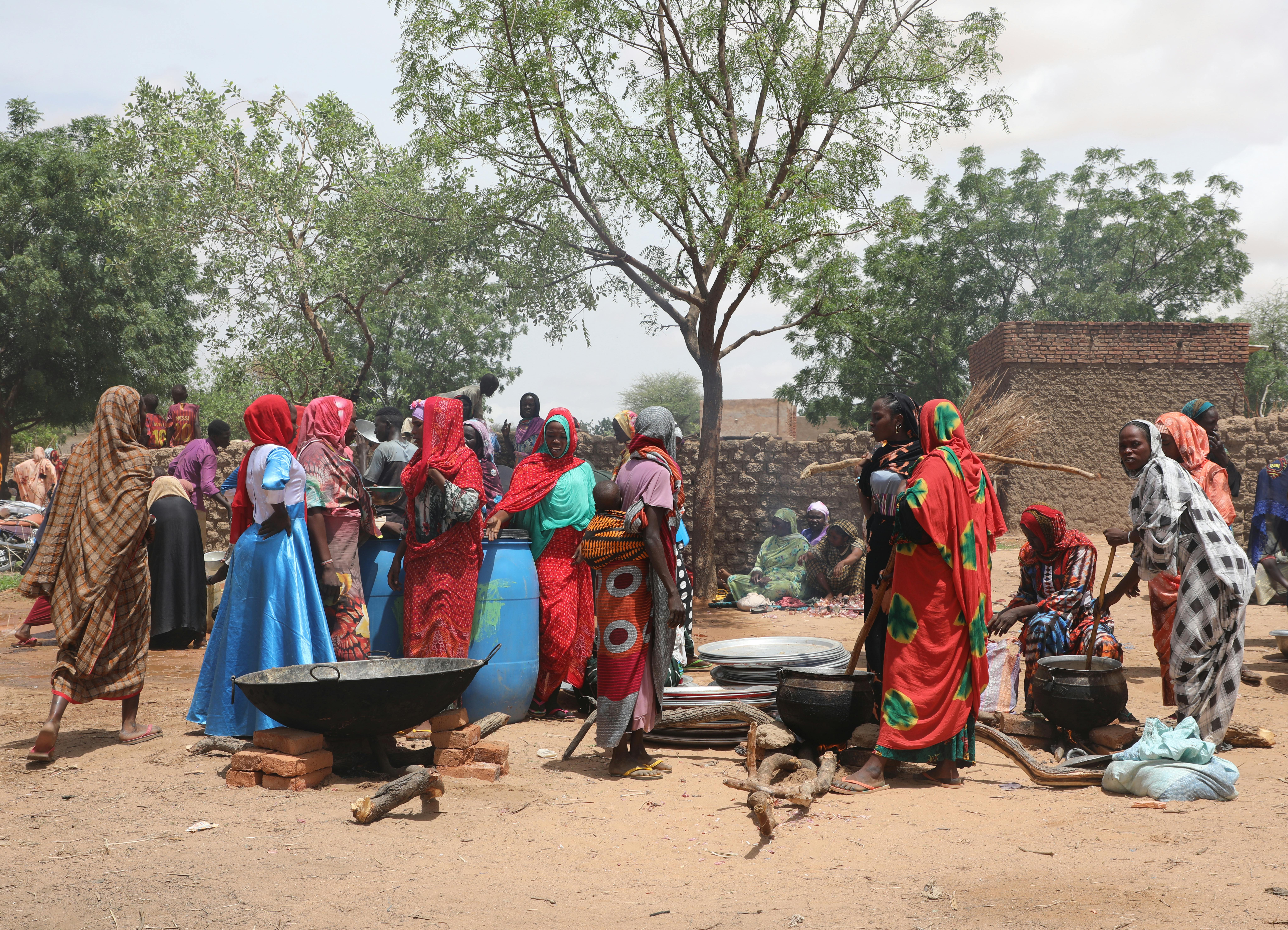 Fuori dalla scuola di Adre, dove migliaia di persone si sono rifugiate dalle violenze del Sudan, le donne del posto cucinano per tutti.