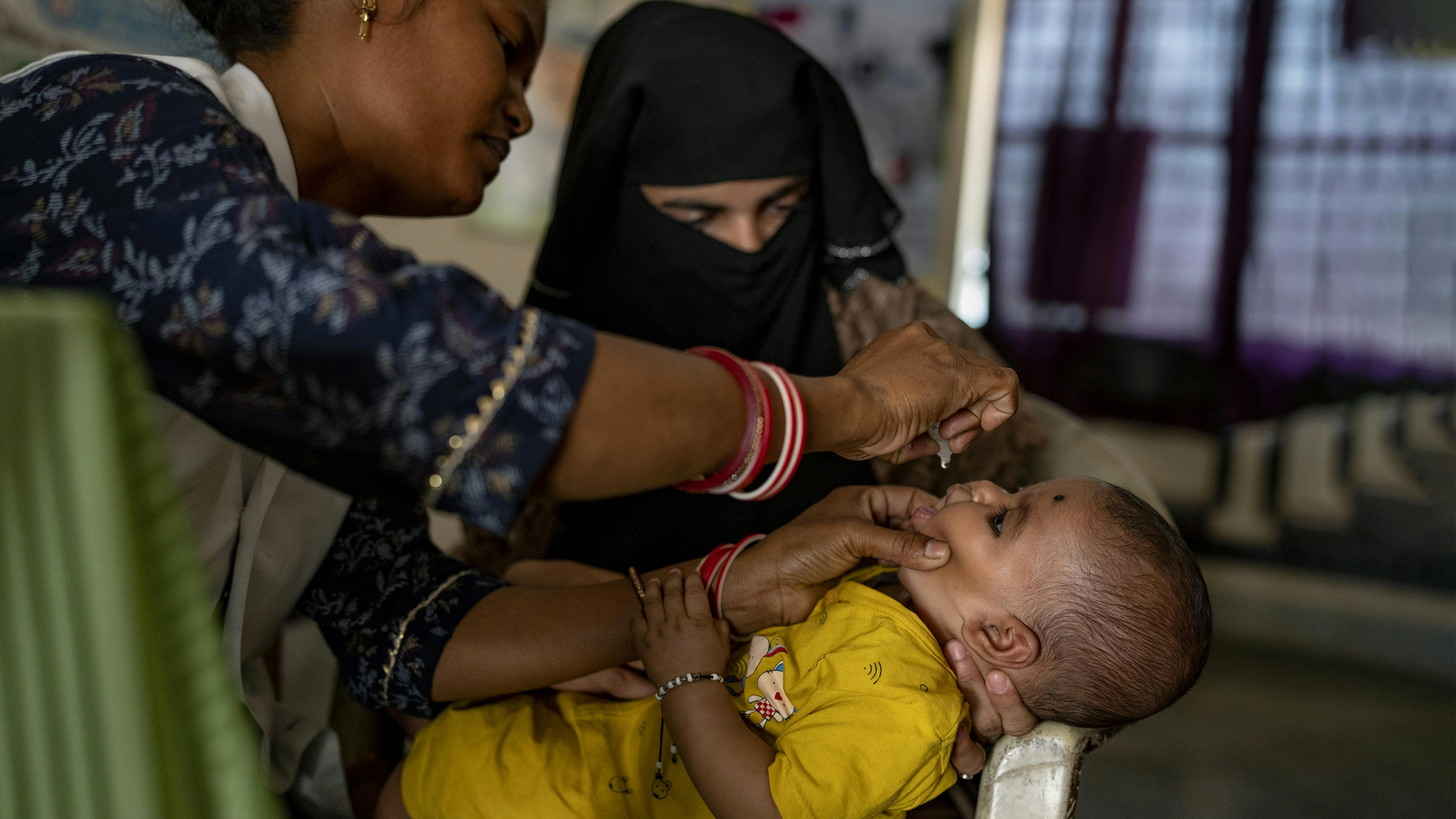 India -L'operatore sanitario Nisa Gari somministra un vaccino orale contro il rotavirus a Mohammad Sijan, un bambino di tre mesi