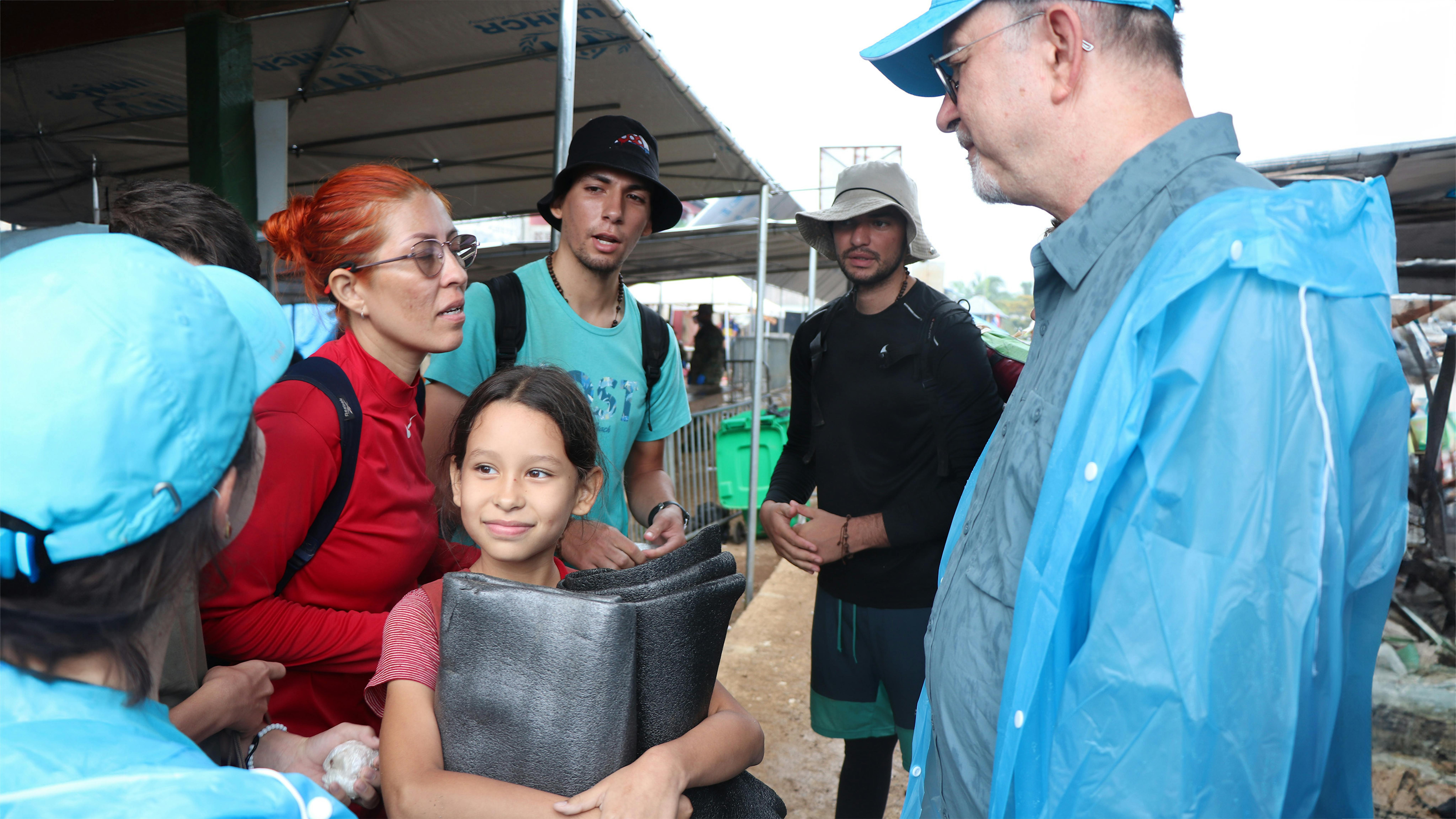 Il DG dell'UNICEF per l'azione umanitaria, Ted Chaiban con il rappr. dell'UNICEF di Panama, Sandie Blanchet, e vicedir. reg.le per l'America Latina e i Caraibi Anne-Claire Duffay parlano alle famiglie dei migranti con bambini che arrivano a Bajo Chiquito, nel Darien Gap .